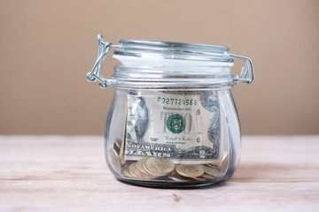 American dollar money in glass jar. world saving day, business, investment, retirement planning, finance concept