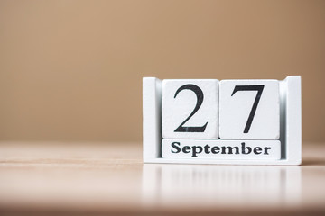 27 September of calendar wooden on table, word tourism day concept