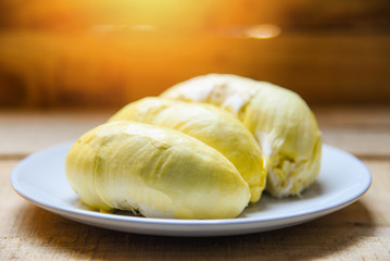 Fresh durian peel tropical fruit summer on white plate and wooden