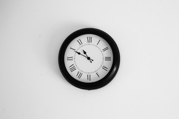 black and white clock on white wall