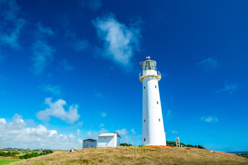 Fototapeta na wymiar A beautiful tall white Cape Egmont Lighthouse.