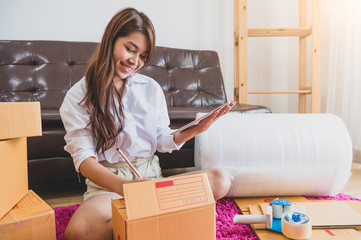 Fototapeta na wymiar Asian business woman startup small business entrepreneur SME distribution warehouse with parcel mail box. small owner home office. Online marketing and product packaging and delivery service concept