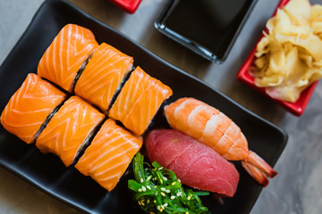 Top view on traditional japanese empty with sushi, ginger, soy sauce, wasabi bowl and chopsticks on concrete grey background, copy space, mockup, flat lay. Online asian food delivery concept