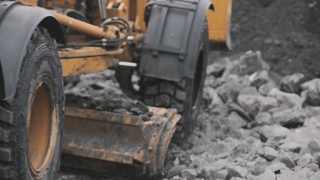 Closeup grader lines the road. Open pit coal mining