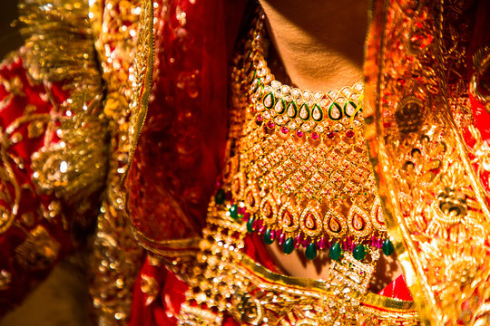 Indian girl wearing a beautiful traditional gold necklace jewelry closeup. - Image