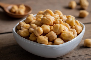 Cooked chick peas in white bowl.