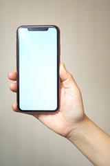 Female hand holding the iphone x