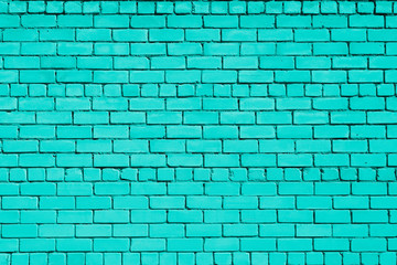 Fototapeta premium Turquoise colored brick background. Brick wall.
