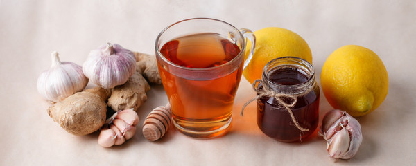 Hot drink with honey, lemon and ginger for cough remedy, seasonal autumn winter alternative...
