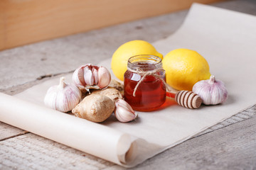 Ingredients for healthy tea with herbs, honey, ginger, garlic and lemon, seasonal traditional flu remedy drink, alternative medicine concept, homeopathy treatment