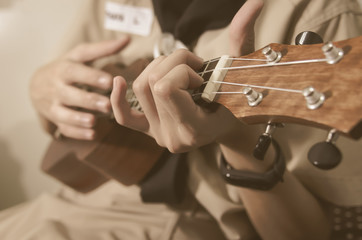 Girl hand playing ukulele