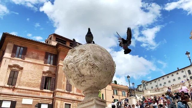 Slow motion of a pigeon flying to a statue.