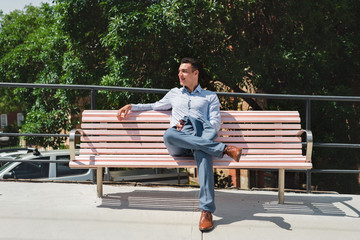 Fototapeta premium man sitting on pink bench