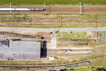 birds eye view of passenger commuter train on a railway track. city industrial district 