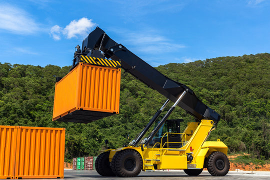 Forklift truck handling cargo shipping container box in logistic shipping yard