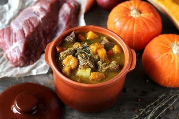 stew with pumpkin and beef. autumn stew in a ceramic pot