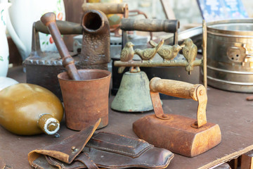 The Antiques are on a junk stall at a flea market.