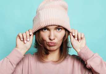 Image of happy young woman wearing pink hat and sweater