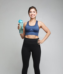 Naklejka premium Sport, people and healthy concept: Resting time. Sporty girl with bottle of water