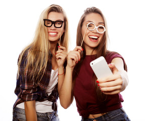 happy best girlfriends making selfie on smartphone over white background