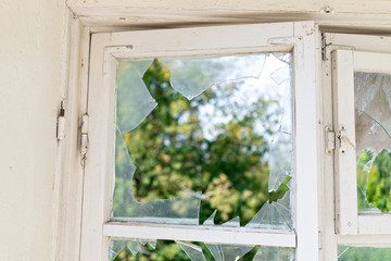 pieces broken glass in window frame