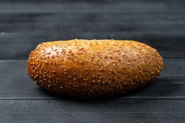 wheat mini baguette on black wooden table