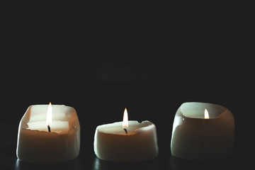 mourning candles on black background