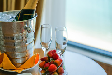 Luxury service at hotel with ocean view, expensive champagne with delicious fruits on table