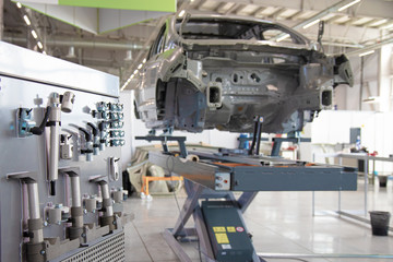 Car frame in a car manufacturing workshop. Collector Tools.