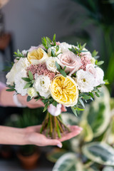 Bridal bouquet with white. Beautiful bouquet of mixed flowers in woman hand. Floral shop concept . Handsome fresh bouquet. Flowers delivery