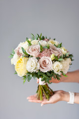 Bridal bouquet. Beautiful bouquet of mixed flowers in woman hand. Floral shop concept . Handsome fresh bouquet. Flowers delivery