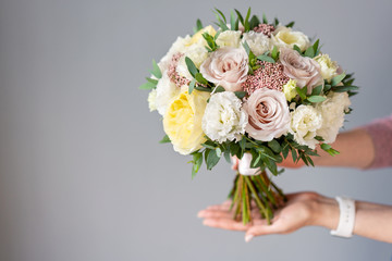 Bridal bouquet with white. Beautiful bouquet of mixed flowers in woman hand. Floral shop concept . Handsome fresh bouquet. Flowers delivery