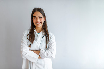 Portrait of an attractive young female caucasian doctor in white coat. Smiling female medical...