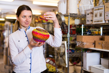 Cheerful woman is standing with home decorations
