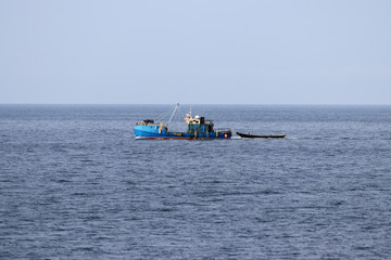 Fishing boats moving in sea.
