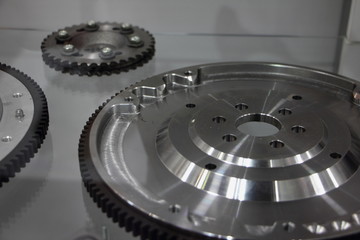 Close up fragment of new flywheel with ring gear, car engine parts