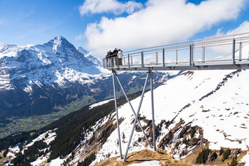 Traveller are resting and photograph on sky cliff walk at First peak of Alps mountain Grindelwald Switzerland