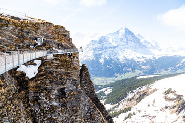 Traveller is photograph imageon sky cliff walk at First peak of Alps mountain , Grindelwald Switzerland