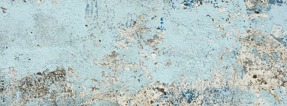 very old and dirty light blue paint texture peeling off the concrete wall for banner background