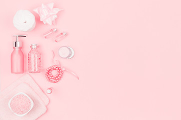 Elegance pink spa cosmetic products for skin and body care on pink background, copy space, flat lay.