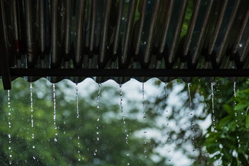 Rain storm with metal sheet roof,rainwater flows down the roof.