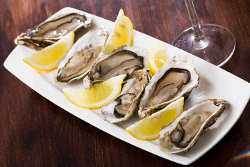 Opened raw oysters with lemon
