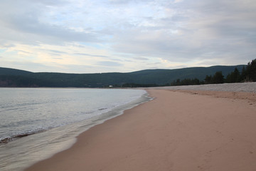 A sandy beach with mountains
