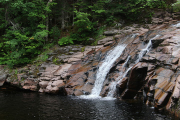 A waterfall flowing down a short cliff