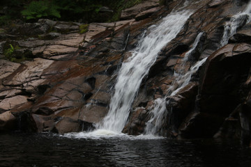 A waterfall flowing down a short cliff