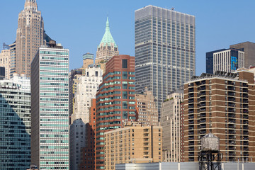 Manhattan cityscape with a water tower in foreground, New York City, USA.