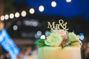 Wedding cake with mr & ms sign on top of the wedding ceremony.