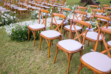 Chair decorated with flowers in Wedding ceremony.