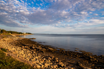 Fototapeta na wymiar A view of a rocky beach under a blue cloudy sky