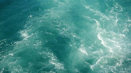 Blue sea water with boat trace. Slow motion.